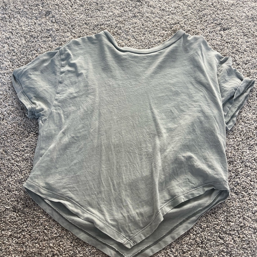 Loose shirt with a v bottom. Light gray with a slight green tint